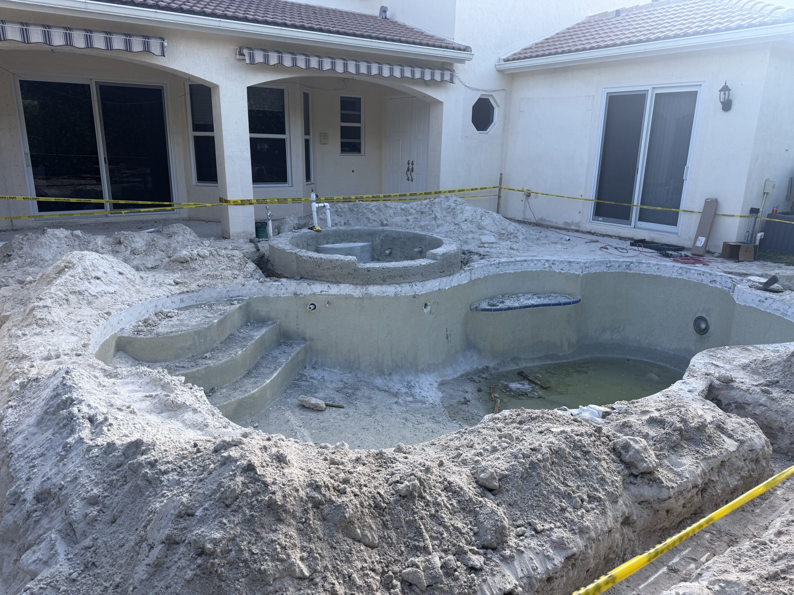 Completed backyard pool renovation and pool deck upgrade in South Florida